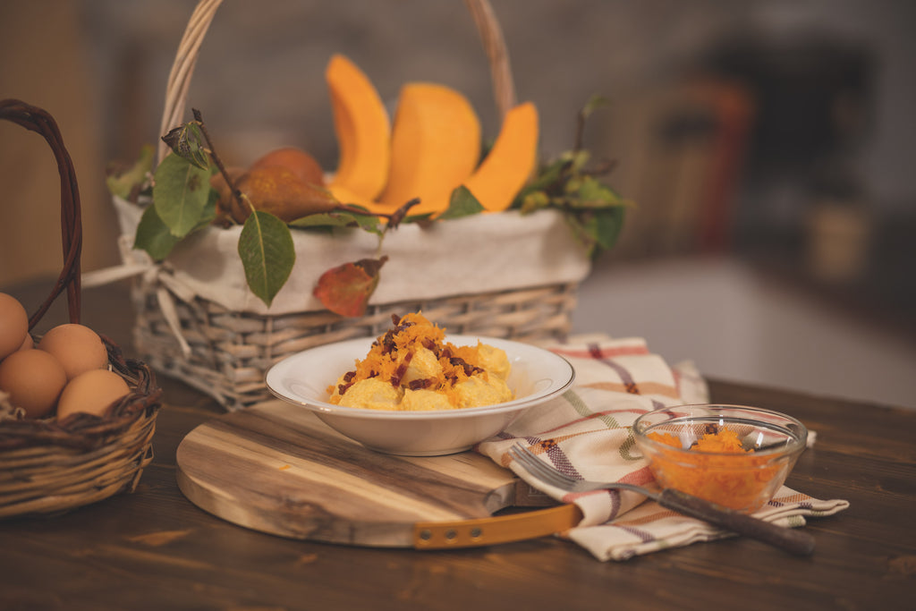 Ricotta gnocchi stuffed with pumpkin & cheese, with cream, saffron and crispy bacon